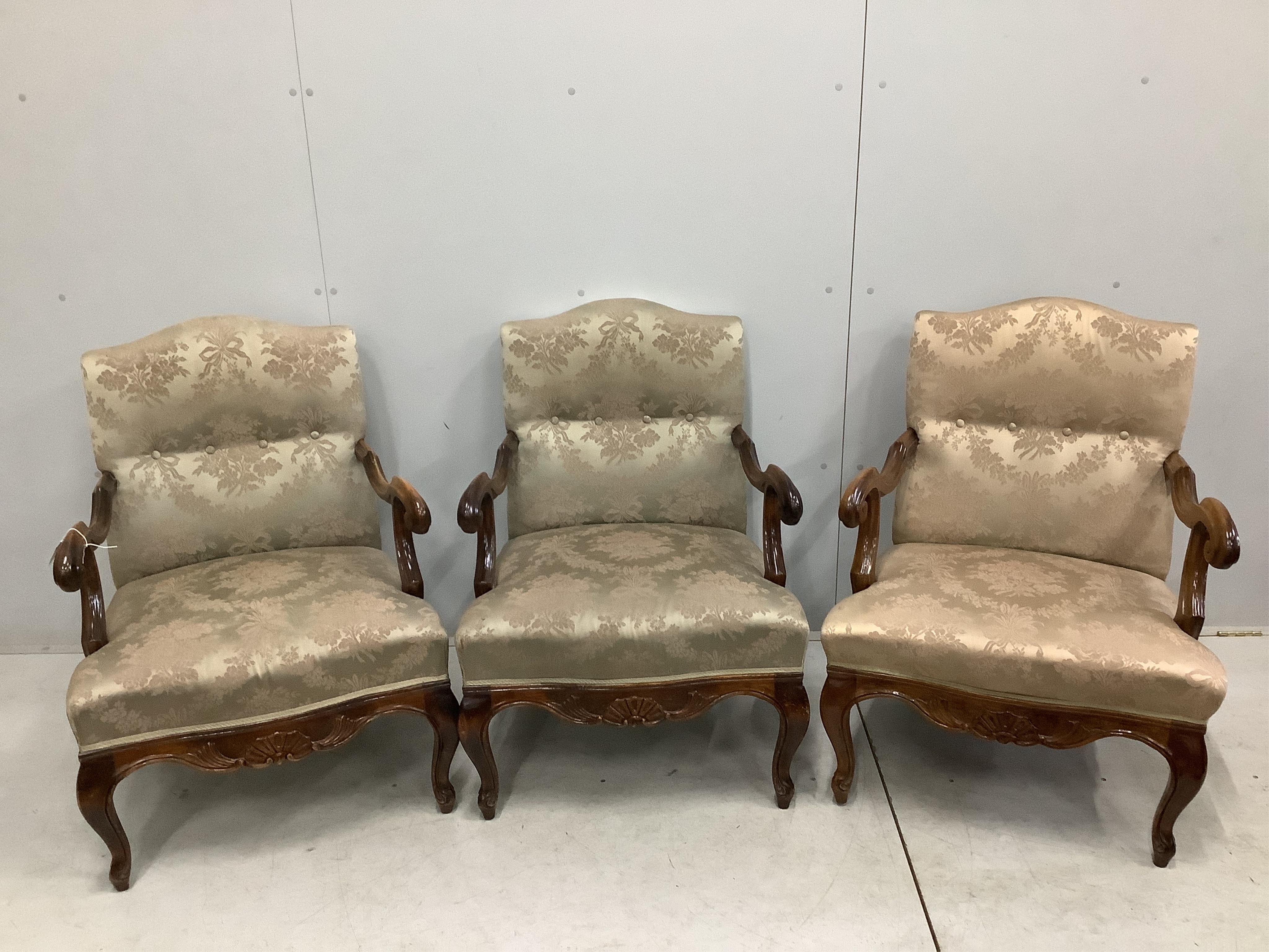 A set of three 18th century style carved walnut beech armchairs, width 59cm, depth 62cm, height 86cm. Condition - fair to good